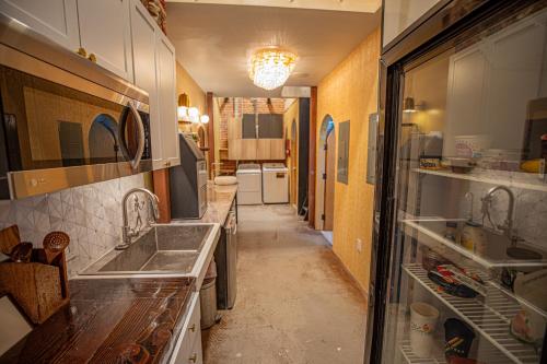 a kitchen with two sinks and a refrigerator at Social Stays - Santa Barbara's FIRST hostel on State Street in Santa Barbara