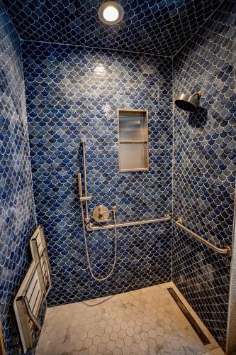 a blue tiled bathroom with a shower with blue tiles at Social Stays - Santa Barbara's FIRST hostel on State Street in Santa Barbara