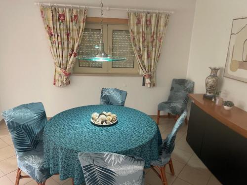 a dining room table with chairs and a bowl of food on it at Vivenda Do Relaxo '' Relax Villa " in Freiria
