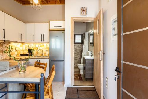 a kitchen with a table and a dining room at Grande Luxury Villa Kalamata - 3 in Kalamata