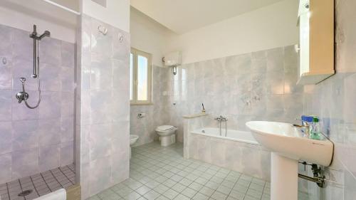 a bathroom with a sink and a shower and a toilet at Livingapple in Scauri