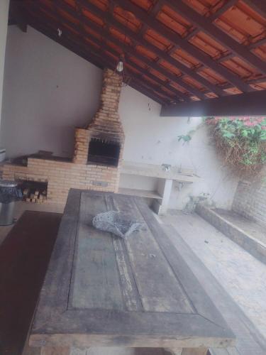 an outdoor patio with a bench and a brick fireplace at Pousada Ondas do Mar Cabo Frio in Cabo Frio