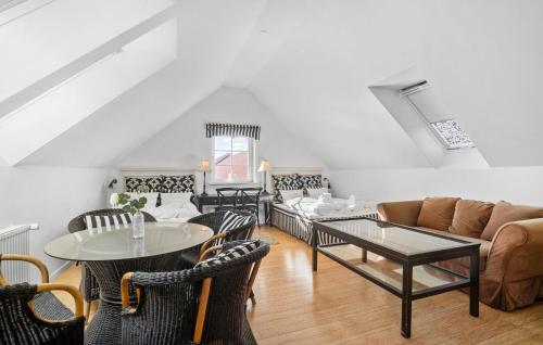 a living room with a couch and tables and chairs at Sommerhus in Skanderborg