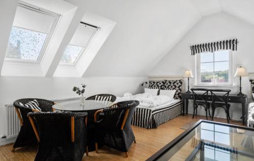 a living room with a table and chairs and a couch at Sommerhus in Skanderborg