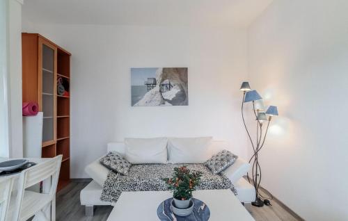 a living room with a couch and a table at Stunning Home In Royan With Wifi in Royan