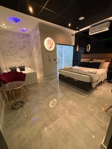 a bedroom with a bed and a table and chairs at DAOS Suites & Terrace Marbella in Marbella