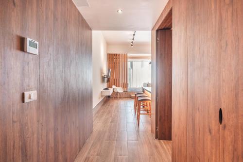 a hallway with wooden walls and a dining room at Probar Suites Punta Cana in Punta Cana