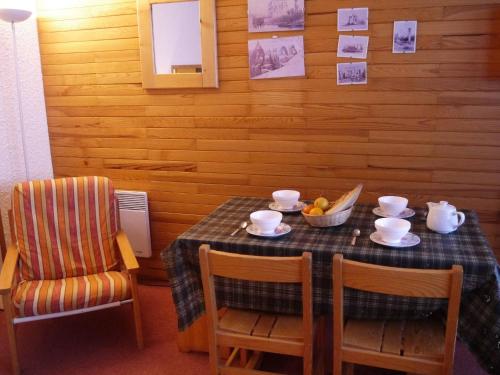 une table de salle à manger avec un bol de fruits dessus dans l'établissement Appartement à Méribel, au pied des pistes, avec balcon et casier à skis - FR-1-355-137, à Méribel
