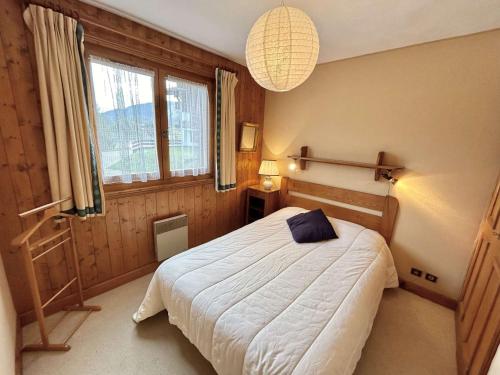 une chambre avec un lit et une grande fenêtre dans l'établissement Appartement 4 pièces + cabine - 8 couchages avec jardin et terrasse - Megève - FR-1-597-22, à Megève