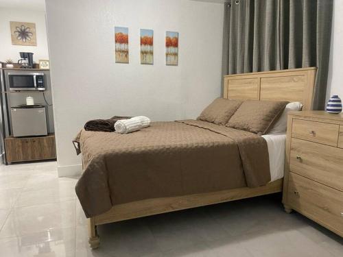 a bedroom with a bed and a dresser at Private and Comfortable Suite near Airport Miami in Miami