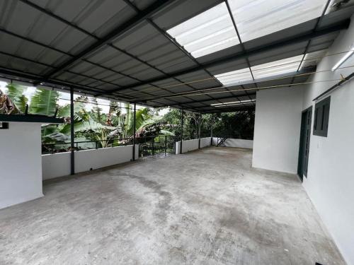 a large empty room with a lot of plants at Dutch Heaven - Luxury Rental Villa Near Cochin Airport in Nedumbassery