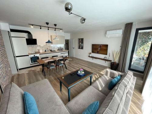 a living room with a couch and a table at Platinum Luxury Industrial 3 Room Unit City-Center in Plovdiv