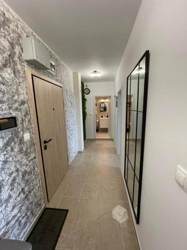 a hallway with a door and a tile floor at Platinum Luxury Industrial 3 Room Unit City-Center in Plovdiv