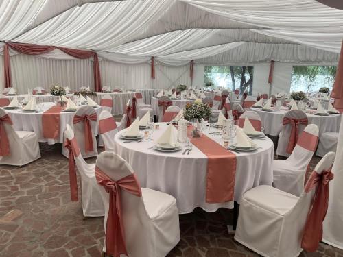 a large tent with tables and chairs in it at Camelot Club Hotel in Vác
