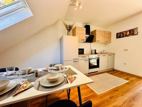 a kitchen and dining room with a table and chairs at Apartment Mirador an der Hohen Wand in NÖ in Grünbach am Schneeberg
