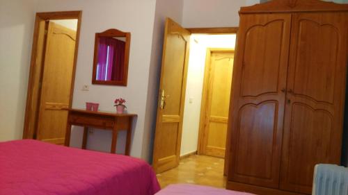 a bedroom with a bed and a large wooden cabinet at Pensión Amparo Las Hayas in Valle Gran Rey