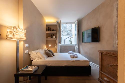 a bedroom with a bed with a teddy bear on it at Iseo Escape - Charm Studio in the Heart of the City in Iseo