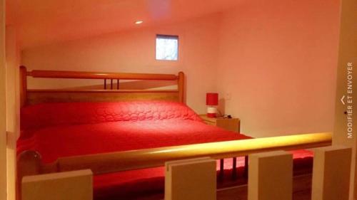 - une chambre avec un lit rouge et une fenêtre dans l'établissement Jean pierre, à Valence