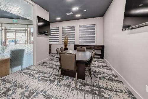 a dining room with a table and chairs at Invermere Inn & Suites in Invermere