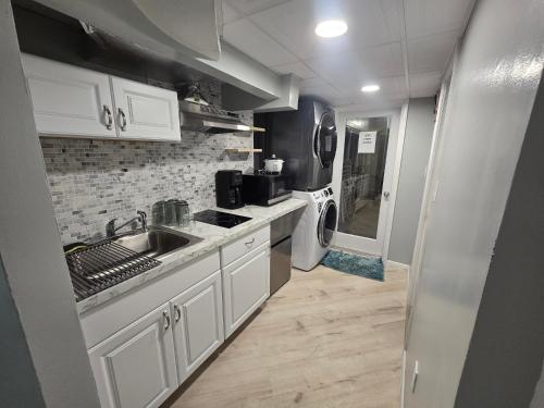 a small kitchen with a sink and a washer and dryer at 3 bedroom w indoor pool hotub in Silver Spring