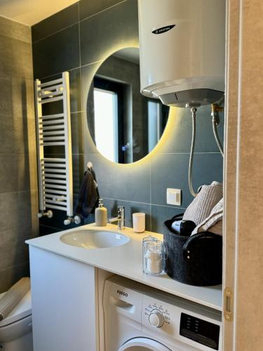a bathroom with a sink and a mirror at Maria Luxury Apartment in Skopje