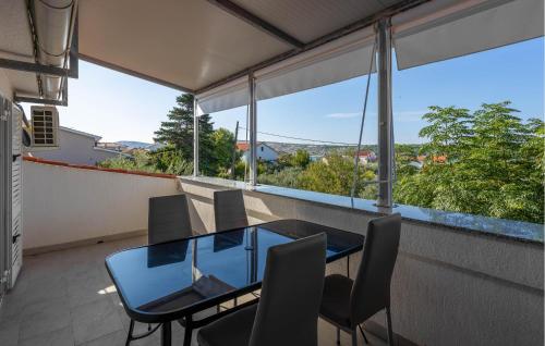 a dining room with a glass table and chairs at Lovely Apartment In Barbat With Wifi in Barbat na Rabu