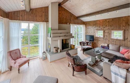 a living room with a couch and a table at Cozy Home In Sjusjøen With Sauna in Sjusjøen