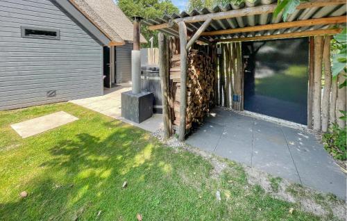 a house with a patio with a large glass door at Pet Friendly Home In Ballum With Sauna in Ballum