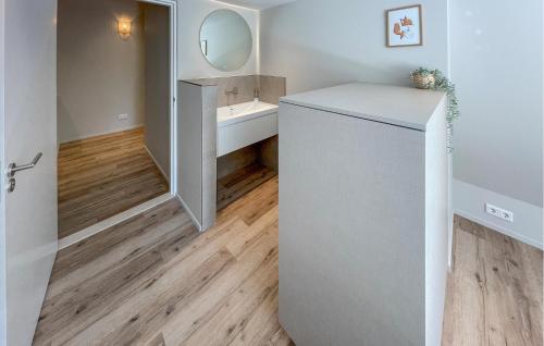 a bathroom with a white refrigerator and a sink at Pet Friendly Home In Ballum With Sauna in Ballum