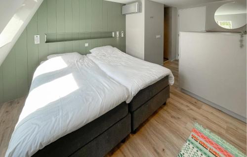 a bedroom with a large bed with white sheets at Pet Friendly Home In Ballum With Sauna in Ballum