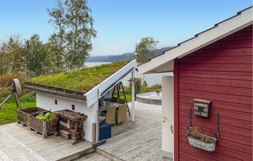 a red and white house with a roof with aiary at Beautiful Home In Eidsvåg I Romsdal in Eidsvåg