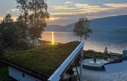 a view of a lake from a house with the sunset at Beautiful Home In Eidsvåg I Romsdal in Eidsvåg