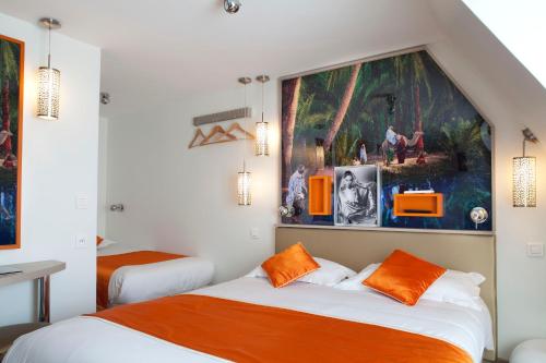 um quarto com duas camas e um quadro na parede em Hôtel Mayet em Paris
