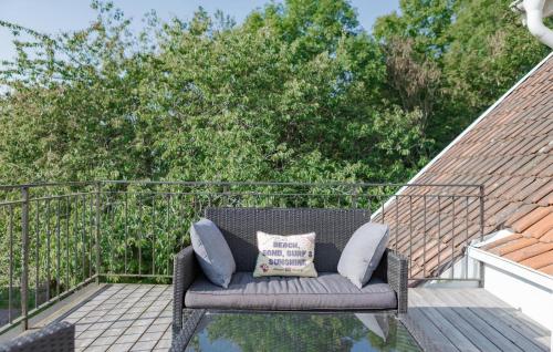 a couch sitting on top of a deck at Lovely Home In Båstad With Sauna in Båstad