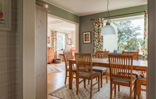 a dining room with a table and chairs at Lovely Home In Båstad With Sauna in Båstad