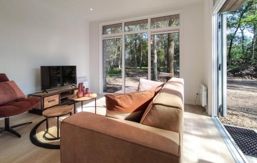 a living room with a couch and a tv at 2 Bedroom Awesome Home In Hellendoorn in Hellendoorn