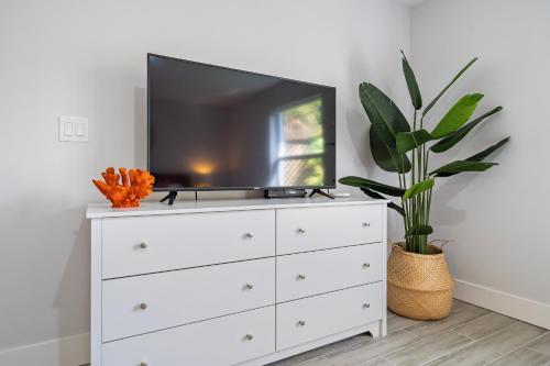 a white dresser with a tv on top of it at New! Few minutes to Downtown, 10 to the Beach! in West Palm Beach
