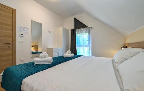 a bedroom with a large bed with towels on it at Amazing Home In Margecan With Wifi in Gačice