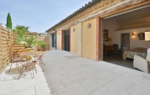 a patio with a table and chairs and a building at Stunning Home In Noves With Wifi in Noves
