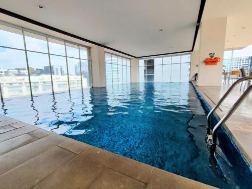 a swimming pool with blue water in a building with windows at Polanco Signaturepool, Paddle, Jacuzzi, 150mbs in Mexico City
