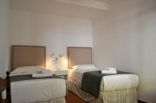 En eller flere senge i et værelse på SunShine Paseo de la Victoria