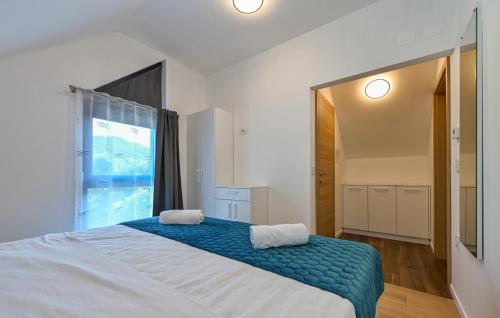 a bedroom with a large bed and a large window at Amazing Home In Margecan With Wifi in Gačice