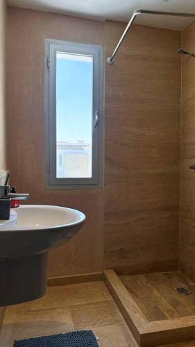 a bathroom with a sink and a window at Villa - Royal Golf de Fez - Pool in Fez