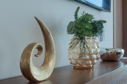 a vase with a plant in it sitting on a table at Sky & Sea View in Mazatlán