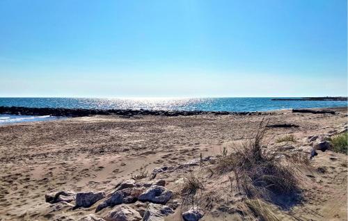 a beach with rocks and the ocean in the background at Stunning Home In Noves With Wifi in Noves