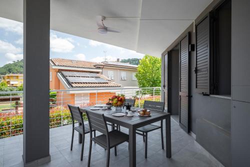 a dining room with a table and chairs on a balcony at Apartment Il Giglio in Montelupo Fiorentino