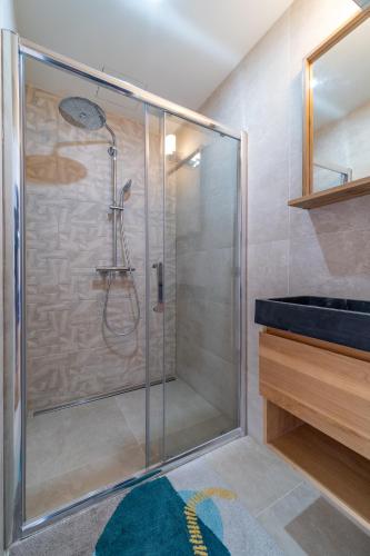 a shower with a glass door in a bathroom at FRATERNiTY-HOTEL in Paris