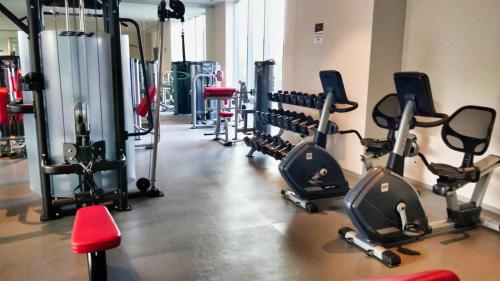 a gym with a bunch of treadmills and machines at Luxurious High-Rise HS WiFi, amazing city views in Mexico City