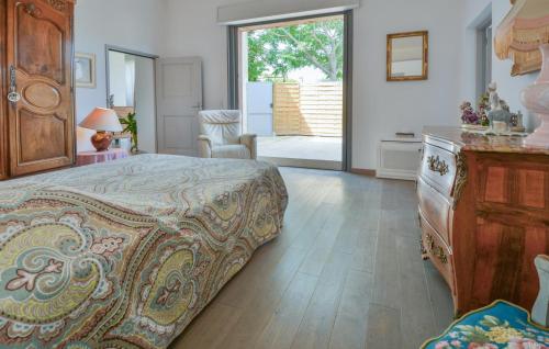 a bedroom with a bed with a dresser and a window at Stunning Home In Noves With Wifi in Noves
