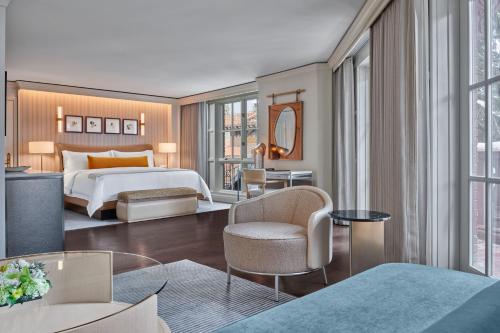 a hotel room with a bed and a chair at St. Regis Aspen Resort in Aspen